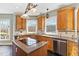 Updated kitchen with granite countertops, wooden cabinets, an island cooktop, and stainless steel appliances at 7700 Circle L Trl, Rougemont, NC 27572