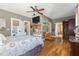 Spacious bedroom featuring hardwood floors, recessed TV and doorway to ensuite bathroom at 7700 Circle L Trl, Rougemont, NC 27572