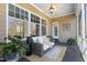Relaxing screened porch with comfortable seating, plants, and overhead fan at 7700 Circle L Trl, Rougemont, NC 27572