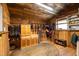 Tack room with wood walls, storage cabinets, and a rug, perfect for organizing equestrian gear at 7700 Circle L Trl, Rougemont, NC 27572