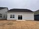 Backyard with a sliding glass door and freshly laid sod, perfect for outdoor entertaining at 107 White Oak Garden Way # 49, Garner, NC 27529