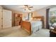 Bedroom with wooden sleigh bed, desk, and window at 110 River Club Way, Youngsville, NC 27596