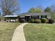 Brick ranch home with covered walkway and landscaping at 1100 Hadley Rd, Raleigh, NC 27610