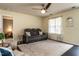 Inviting living room with a plush sofa, decorative rug, and modern ceiling fan at 121 Holly Mountain Rd, Holly Springs, NC 27540