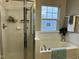Bathroom with soaking tub, shower, and a window for natural light at 1211 Canyon Rock Ct # 111, Raleigh, NC 27610