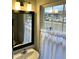 Bathroom with a sink, mirror, and window with curtains at 1211 Canyon Rock Ct # 111, Raleigh, NC 27610