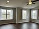 Spacious bedroom with hardwood floors and large windows offering natural light at 1211 Canyon Rock Ct # 111, Raleigh, NC 27610
