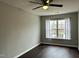 Cozy bedroom with dark hardwood floors and a large window at 1211 Canyon Rock Ct # 111, Raleigh, NC 27610