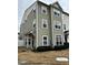 Three-story townhome with neutral siding and landscaping at 1211 Canyon Rock Ct # 111, Raleigh, NC 27610