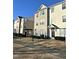 Three-story townhome with neutral siding and landscaping at 1211 Canyon Rock Ct # 111, Raleigh, NC 27610
