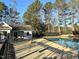 Community swimming pool with surrounding trees and a pool house at 1211 Canyon Rock Ct # 111, Raleigh, NC 27610