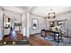Bright entryway with hardwood floors, an office space, and views into the living room at 127 Preston Trce, Pittsboro, NC 27312