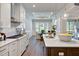 Modern kitchen with white cabinets, quartz countertops, and island at 127 Preston Trce, Pittsboro, NC 27312