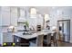 Modern kitchen with white cabinets, a large island, and stainless steel appliances at 127 Preston Trce, Pittsboro, NC 27312