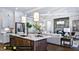 Open kitchen features a large island and flows into the adjacent living room at 127 Preston Trce, Pittsboro, NC 27312