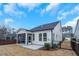 Expansive backyard view featuring a well-manicured lawn and a white home exterior with a screened-in porch at 12408 Angel Vale Pl, Durham, NC 27703