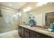 Modern bathroom featuring granite countertops, double sinks and walk-in shower at 12408 Angel Vale Pl, Durham, NC 27703