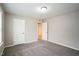 Comfortable carpeted bedroom with neutral walls and modern doors at 12408 Angel Vale Pl, Durham, NC 27703