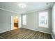 Spacious bedroom with ample natural light, hardwood floors, and adjoining bathroom at 12408 Angel Vale Pl, Durham, NC 27703