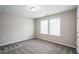 Inviting bedroom with plush carpet, neutral walls, and bright window at 12408 Angel Vale Pl, Durham, NC 27703