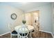 Charming dining area with a round table, four chairs, modern art, and neutral walls at 12408 Angel Vale Pl, Durham, NC 27703