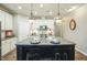 Bright kitchen featuring granite counters, a large island with seating, and stylish pendant lighting at 12408 Angel Vale Pl, Durham, NC 27703