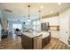 Open-concept kitchen featuring granite countertops, stainless steel appliances, and seamless flow to the living space at 12408 Angel Vale Pl, Durham, NC 27703