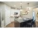 Stylish kitchen with white cabinets, granite counters, stainless steel appliances, and a center island at 12408 Angel Vale Pl, Durham, NC 27703