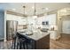 Well-lit kitchen with stainless steel appliances, granite counters and an island with bar stool seating at 12408 Angel Vale Pl, Durham, NC 27703
