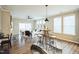 Open-concept living room with modern furnishings, natural light, and wood flooring at 12408 Angel Vale Pl, Durham, NC 27703