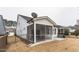 White siding house with a screened in porch, and a manicured lawn surrounded by a black metal fence at 12408 Angel Vale Pl, Durham, NC 27703