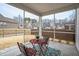 Relaxing screened porch with views of the backyard and surrounding neighborhood, furnished with a table and chairs at 12408 Angel Vale Pl, Durham, NC 27703