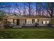 Ranch style home with a spacious lawn and mature trees at 1508 Carroll Heights Rd, Zebulon, NC 27597