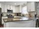 L-shaped kitchen with granite counters and stainless steel appliances at 1508 Carroll Heights Rd, Zebulon, NC 27597