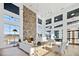 Open living area with stone fireplace and multiple windows offering scenic views at 1565 Goldfinch Perch Ln, Knightdale, NC 27545
