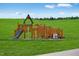 Wooden playground structure with slides and climbing areas for children at 1565 Goldfinch Perch Ln # 353, Knightdale, NC 27545