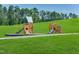 Two wooden playsets on grassy area at 1565 Goldfinch Perch Ln, Knightdale, NC 27545