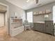 Bright Bedroom with a rocking chair, bookshelf and changing table at 1700 Southern Hills Ct, Raleigh, NC 27604