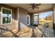 View of the wooden back porch featuring a ceiling fan and a screened-in section overlooking the yard at 182 River Ridge Ln, Timberlake, NC 27583