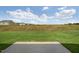 Grass backyard with patio and distant houses view at 192 Paper Birch Way, Fuquay Varina, NC 27526