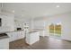 Bright kitchen features granite counters, white cabinets, and access to backyard at 192 Paper Birch Way, Fuquay Varina, NC 27526