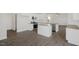Modern kitchen with island, stainless steel appliances, and hardwood floors at 192 Paper Birch Way, Fuquay Varina, NC 27526