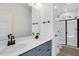 Bathroom boasts double vanity, grey cabinets and a large walk-in shower at 203 Royal St, Fuquay Varina, NC 27526