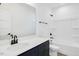 Clean bathroom with a white tub and vanity, and dark blue cabinets at 203 Royal St, Fuquay Varina, NC 27526