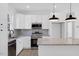 Modern kitchen featuring granite countertops and stainless steel appliances at 203 Royal St, Fuquay Varina, NC 27526