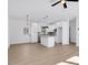 Modern kitchen with white cabinets, granite island, and stainless steel appliances at 203 Royal St, Fuquay Varina, NC 27526