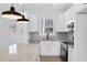 Modern kitchen features white cabinets, granite countertops, and stainless steel appliances at 203 Royal St, Fuquay Varina, NC 27526