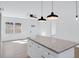Modern kitchen with white cabinets, granite island, and stainless steel appliances at 203 Royal St, Fuquay Varina, NC 27526
