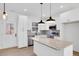 Modern kitchen with white cabinets, granite countertops, and stainless steel appliances at 203 Royal St, Fuquay Varina, NC 27526