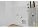 Laundry room with wire shelving, water heater, and ample space at 203 Royal St, Fuquay Varina, NC 27526